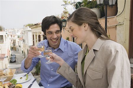 Couple toasting at a table with Greek food Stock Photo - Premium Royalty-Free, Code: 644-01631317