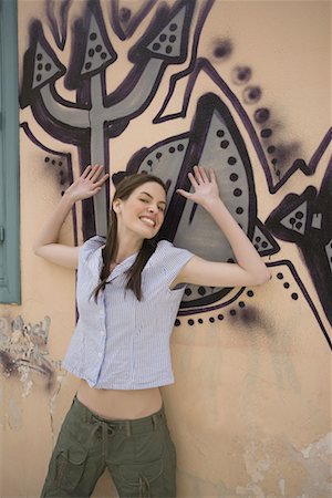 simsearch:644-01631409,k - Woman at wall with graffiti, arms up Stock Photo - Premium Royalty-Free, Code: 644-01631350