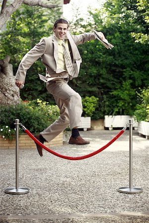 simsearch:644-01825388,k - Businessman in garden jumping over barrier Foto de stock - Sin royalties Premium, Código: 644-01631456