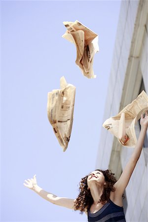 simsearch:644-01631428,k - Happy businesswoman throwing newspaper in the air Stock Photo - Premium Royalty-Free, Code: 644-01631484