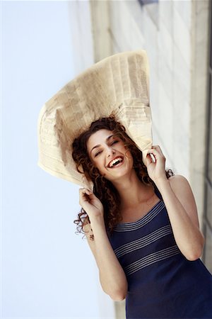 Happy businesswoman with newspaper on head Stock Photo - Premium Royalty-Free, Code: 644-01631486
