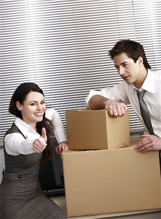 Business people in office with boxes Stock Photo - Premium Royalty-Free, Code: 644-01825354