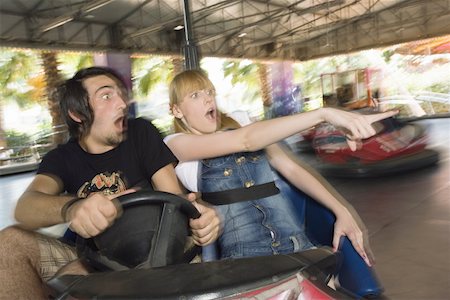 Teenage couple in bumper car in amusement park Stock Photo - Premium Royalty-Free, Code: 644-01825560