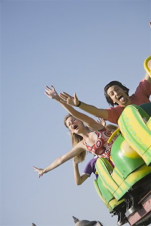people riding roller coasters - Teenagers on amusement park ride Foto de stock - Sin royalties Premium, Código: 644-01825596