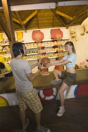 Teenage couple at game in amusement park Stock Photo - Premium Royalty-Free, Code: 644-01825646