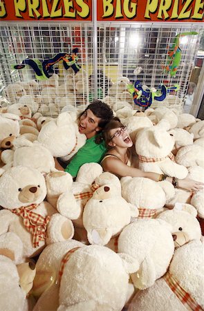 easygoing - Teenage couple among teddy bears in arcade Stock Photo - Premium Royalty-Free, Code: 644-01825666