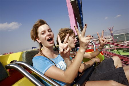 Teenage couple on amusement park ride Stock Photo - Premium Royalty-Free, Code: 644-01825685