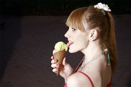 Female teenager eating an ice cream cone Stock Photo - Premium Royalty-Free, Code: 644-01825747