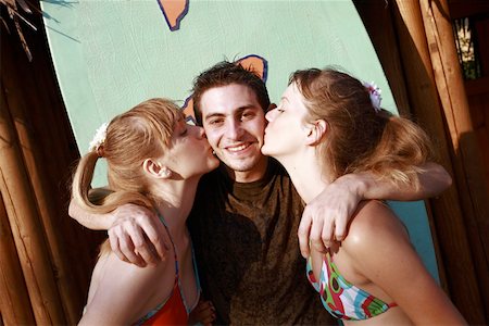 fair people clothing color - Two female teenagers kissing male teenager on cheek Stock Photo - Premium Royalty-Free, Code: 644-01825741