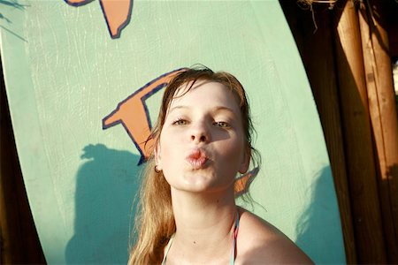 Female teenager blowing a kiss Stock Photo - Premium Royalty-Free, Code: 644-01825742