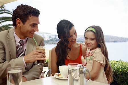 french cafe, people - Couple with daughter at seaside cafe table Stock Photo - Premium Royalty-Free, Code: 644-01825779
