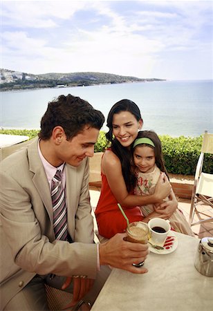 spanish mom daughter beach - Couple with daughter at seaside cafe table Stock Photo - Premium Royalty-Free, Code: 644-01825780