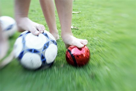 feet green - Two children's legs with balls Stock Photo - Premium Royalty-Free, Code: 644-02060436