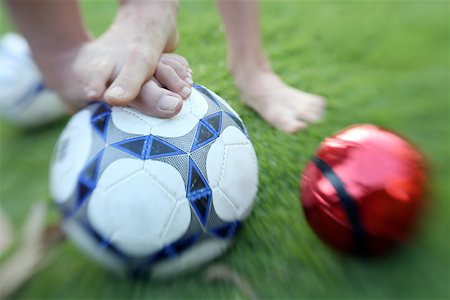 feet green - Two children's feet with balls Stock Photo - Premium Royalty-Free, Code: 644-02060439