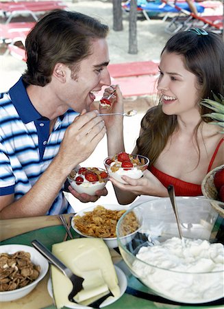 Young adult couple feeding each other breakfast Stock Photo - Premium Royalty-Free, Code: 644-02060545