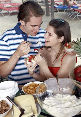 Young adult couple feeding each other breakfast Stock Photo - Premium Royalty-Free, Code: 644-02060546