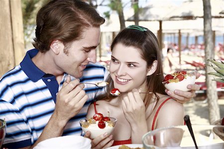 Young adult couple feeding each other breakfast Stock Photo - Premium Royalty-Free, Code: 644-02060548