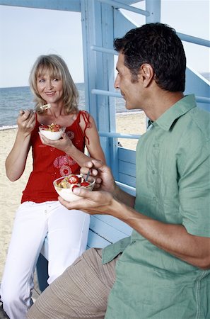 Mature adult couple eating breakfast at beach Stock Photo - Premium Royalty-Free, Code: 644-02060565