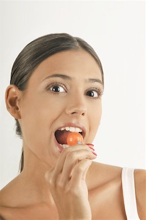eat mouth closeup - Female young adult eating a lollipop Stock Photo - Premium Royalty-Free, Code: 644-02152683