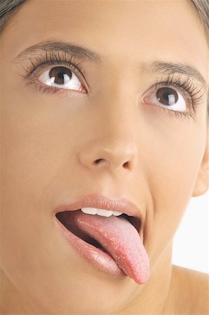 Female young adult face;tongue out Stock Photo - Premium Royalty-Free, Code: 644-02152694