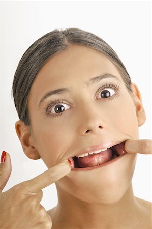 Female young adult face; stretching mouth open Stock Photo - Premium Royalty-Free, Code: 644-02152706