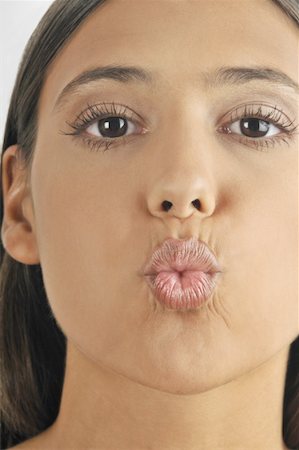 Female young adult blowing a kiss Stock Photo - Premium Royalty-Free, Code: 644-02152741