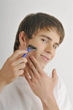 simsearch:644-02152773,k - Young male adult shaving face with razor Stock Photo - Premium Royalty-Free, Code: 644-02152765