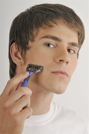simsearch:644-02152773,k - Young male adult shaving face with razor Stock Photo - Premium Royalty-Free, Code: 644-02152760
