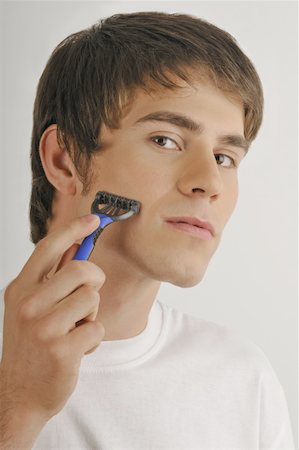 simsearch:644-02152773,k - Young male adult shaving face with razor Stock Photo - Premium Royalty-Free, Code: 644-02152762