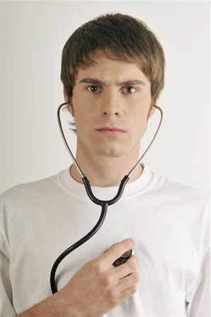 stethoscope, heart - Jeune mâle adulte avec stéthoscope Photographie de stock - Premium Libres de Droits, Code: 644-02152786