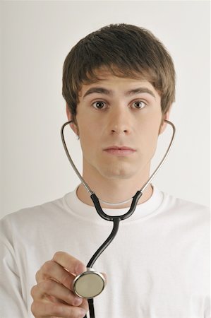 stethoscope, heart - Jeune mâle adulte avec stéthoscope Photographie de stock - Premium Libres de Droits, Code: 644-02152787