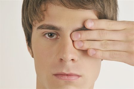 simsearch:644-02152773,k - Young male adult;hand covering one eye Stock Photo - Premium Royalty-Free, Code: 644-02152853