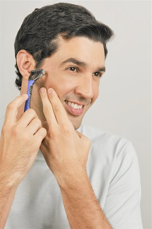 simsearch:644-02152773,k - Young male adult shaving face with razor Stock Photo - Premium Royalty-Free, Code: 644-02152974