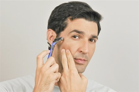 simsearch:644-02152773,k - Young male adult shaving face with razor Stock Photo - Premium Royalty-Free, Code: 644-02152972