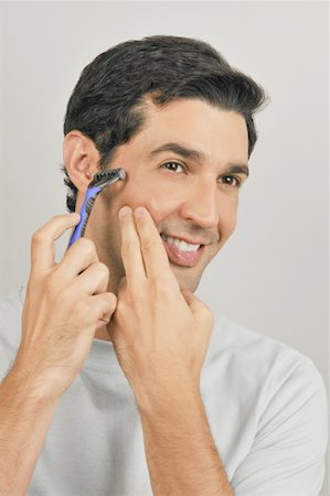 simsearch:644-02152773,k - Young male adult shaving face with razor Stock Photo - Premium Royalty-Free, Code: 644-02152973
