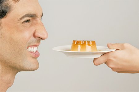 simsearch:644-02153100,k - Young male adult being offered a dessert Stock Photo - Premium Royalty-Free, Code: 644-02152982