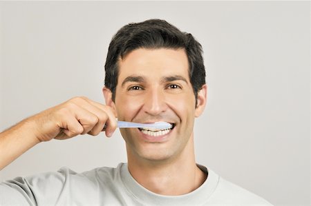simsearch:644-02152773,k - Young male adult brushing teeth Stock Photo - Premium Royalty-Free, Code: 644-02152996