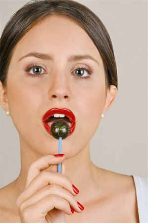 simsearch:644-02153100,k - Female young adult eating a lollipop Stock Photo - Premium Royalty-Free, Code: 644-02153075