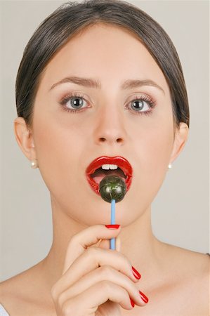 eat mouth closeup - Female young adult eating a lollipop Stock Photo - Premium Royalty-Free, Code: 644-02153073
