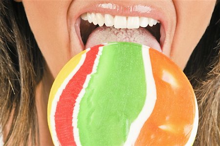 Female adult closeup eating a lollipop Stock Photo - Premium Royalty-Free, Code: 644-02153105