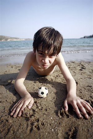 Boy with small soccer ball on beach Stock Photo - Premium Royalty-Free, Code: 644-02153126