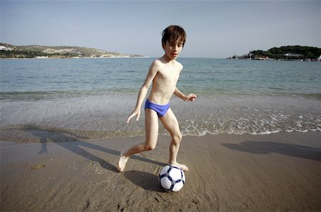 Boy with soccer ball on beach Stock Photo - Premium Royalty-Free, Code: 644-02153128
