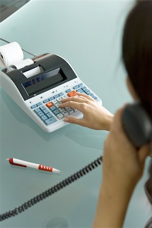 Professional woman on telephone using calculator Foto de stock - Sin royalties Premium, Código: 644-02922944