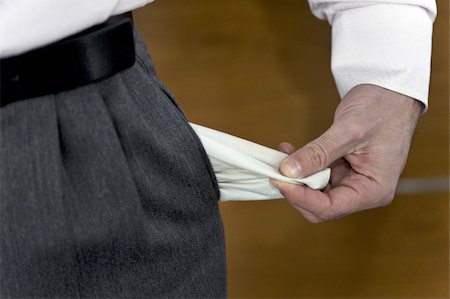 Businessman pulling out empty pocket Foto de stock - Sin royalties Premium, Código: 644-02922999