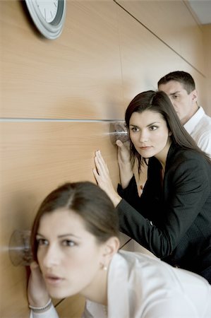 simsearch:644-02923130,k - Office workers eavesdropping against wall Foto de stock - Royalty Free Premium, Número: 644-02923095