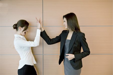 smile and greeting - Businesswomen doing high five Stock Photo - Premium Royalty-Free, Code: 644-02923101