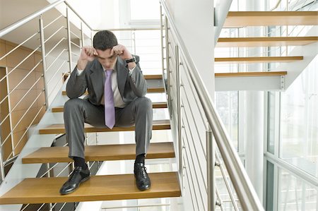 simsearch:644-02923252,k - Homme d'affaires sur l'escalier de bureau avec la tête dans les mains Photographie de stock - Premium Libres de Droits, Code: 644-02923133