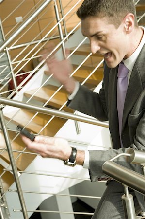 simsearch:644-02923148,k - Businessman on staircase shouting at cell phone Foto de stock - Sin royalties Premium, Código: 644-02923203