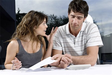 resignation - Young couple with check and calculator Stock Photo - Premium Royalty-Free, Code: 644-02923391