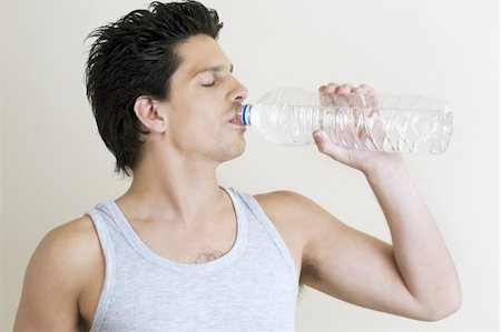 skinny man - Young man drinking bottled water Stock Photo - Premium Royalty-Free, Code: 644-02923400